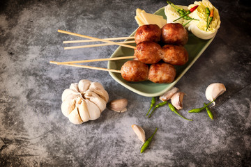 Thai sausage with fresh vegetables and peppers on a concrete background