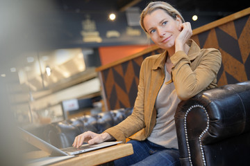 young businesswoman smiling in a cafeteria