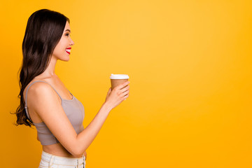 Profile side copyspace photo of cheerful cute pretty nice girlfriend holding cup of coffee with lips pomaded looking into empty space adverting tea isolated vivid color background