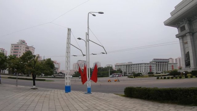 A Van Drives Past Arch of Triumph. Pyongyang, North Korea. Panning Left Shot