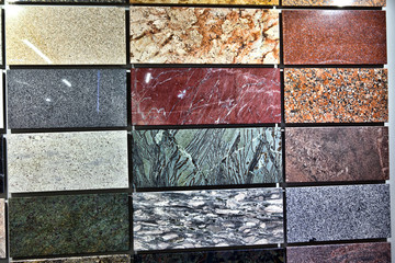 Colorful samples of a stone tile in store. Marble and granite flooring a most popular choice for modern kitchens and bathrooms.