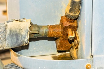 an old and rusty leaking pipe of central air conditioning unite fixed into AC heavy duty compressor