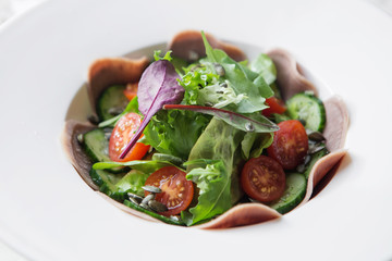 Boiled beef tongue with garnish salad on white background 