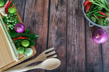Herbs and spices arrange as frame on wooden background