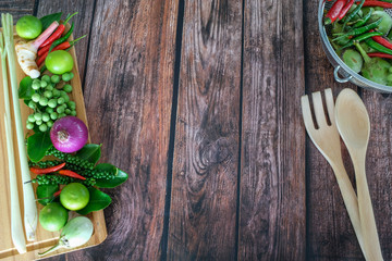 Herbs and spices arrange as frame on wooden background