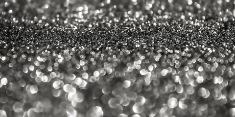 Dark silver abstract sparkler background.