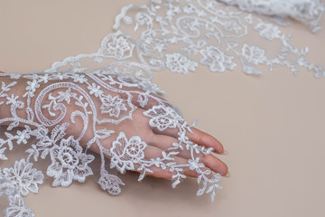 Texture lace fabric. lace on white background studio. thin fabric made of yarn or thread. a background image of ivory-colored lace cloth. White lace on beige background.