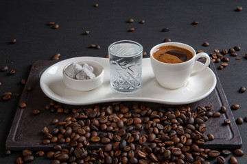 Turkish coffee with Turkish delight on black wooden background