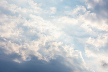 landscape sky with blue clouds and sunbeams at sunset. Background texture