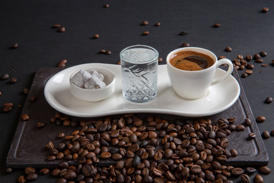 Turkish coffee with Turkish delight on black wooden background