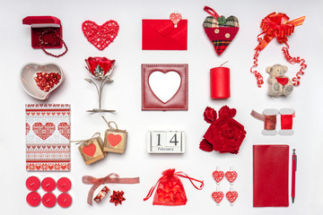Stylish accessories, decorative items and miniature toys in red color on white background. Calendar date February 14, greeting card for Valentine's day. Love and romance concept. Copy space, mock up