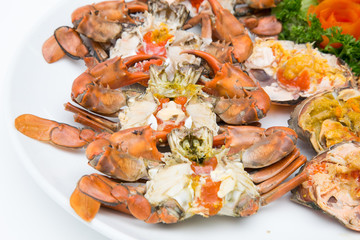 Boiled crab fresh and hot - delicious appetizer Steamed crabs and crab's spawn with seafood spicy sauce Thai seafood, steamed crab showing the delicious crab's eggs inside its shell.