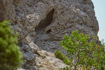 Stone cliffs in the mountains. Rocky slope. Natural background