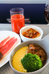 photo of Food served on board of business class airplane on the table