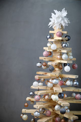Alternative Christmas tree . the original Christmas tree in the new year of wood boards, decorated...