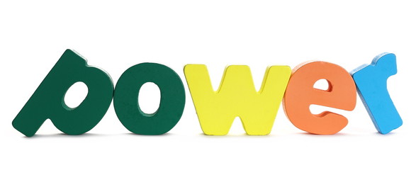 Colorful wooden alphabet letters spelling out word power isolated on white background