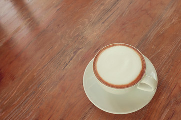 Cup of coffee cappuccino on wooden bar in cafe. Aroma cappuccino, A cup of coffee on a wooden table in the cafe.