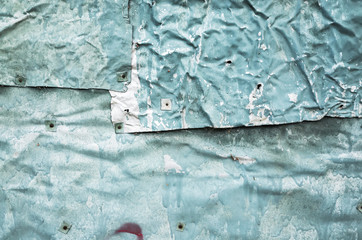 Crumpled metal sheets, abandoned wall