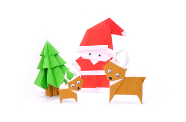 Origami Christmas paper art, Santa Claus, reindeer and Christmas tree for greeting season of Christmas and New year. Copy space