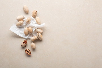 Fresh pecan nuts on stone background and copy space