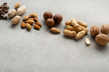 Assortment of fresh nuts on gray background