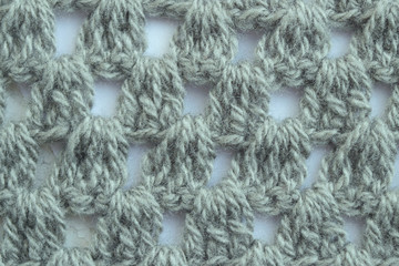 Knitting. Crochet pattern background. The yarn is dark green.
