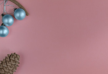 Christmas composition with silver balls and pine cone on a pink background. Flat lay, New Year, top view, copy space, minimalism, New Year card.