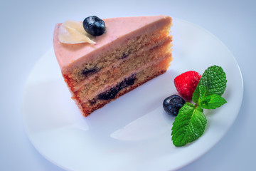 Cake chocolate with yogurt cream and blueberries fruits isolated on blue background