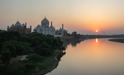 Taj Mahal from the riverbank during a sunset