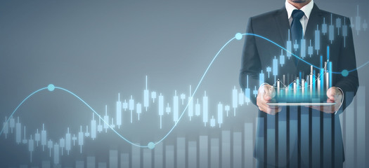 Businessman plan graph growth and increase of chart positive indicators in his business,tablet in hand