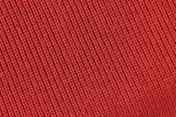 Red background from red knitted wool closeup 