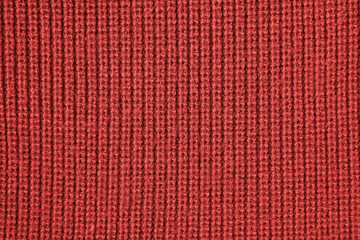 Red background from red knitted wool closeup 