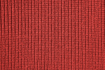 Red background from red knitted wool closeup 
