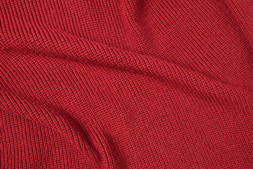 Red background from red knitted wool closeup 