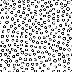 Seamless neutral pattern. Black hand-drawn rings on a white background. Scandinavian cozy ornament. Vector illustrations with circles for wallpaper, posters, wrapping paper, textiles