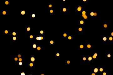 Golden glitter. Bokeh circles on black background. Holiday