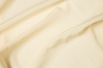 Fototapeta na wymiar Abstract folds. Delicate silk drapery. Beige color.