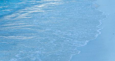 Separate view of a tropical island with turquoise sea, coconut palm trees and blue sky in the Maldives. Indian Ocean Sunset