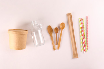 Flatlay composition with eco friendly reusable items for take out and grocery shopping with a lot of copy space for text on paper textured background. Close up, top view.