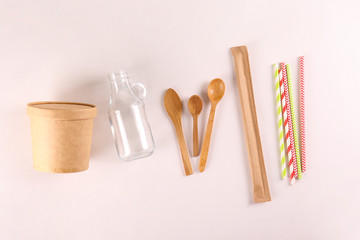 Flatlay composition with eco friendly reusable items for take out and grocery shopping with a lot of copy space for text on paper textured background. Close up, top view.