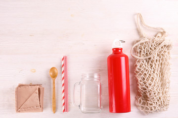 Flatlay composition with eco friendly reusable items for take out and grocery shopping with a lot of copy space for text on paper textured background. Close up, top view.