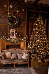 Christmas background with illuminated fir tree with golden decpration and fireplace in living room. Cozy holiday home