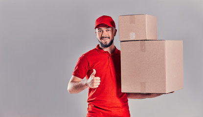 Man on gray background. Courier, Delivery Man.
