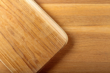 Wooden cutting board on a oak table.