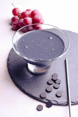 Black yogurt with activated carbon and red grapes