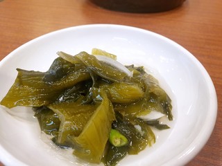 Selective focus of seaweed salad in white plate on wooden table, Hiyashi wakame or Chuka wakame is Japanese traditional, Ready to eat or serve
