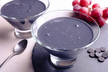 Black yogurt with activated carbon and red grapes