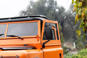 Vintage orange color 4x4 off-road car, the car is old and has been modified. © Aylin