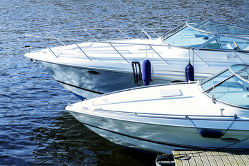 Boats, pier on blue background. Coast landscape Bay. A relaxing beach scene. Summer vacation. Summer background. Sea transport. Holiday travel. Luxury travel.