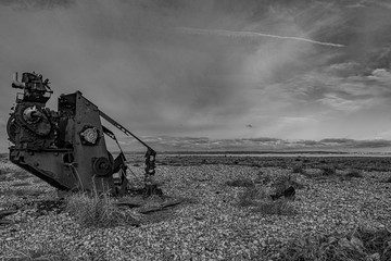Fototapeta premium Old broken engine abandoned on stony beach in Dungeness, England